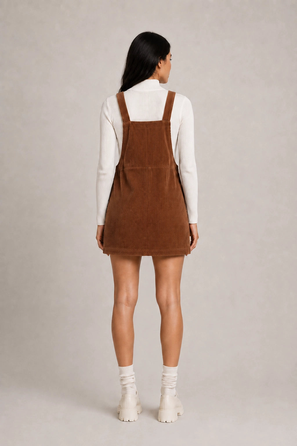 Brown pinafore dress back view with adjustable shoulder straps and mini length