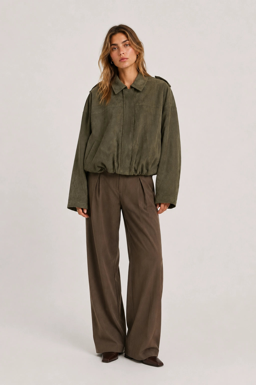Olive green cropped jacket with button front and elastic waist hem