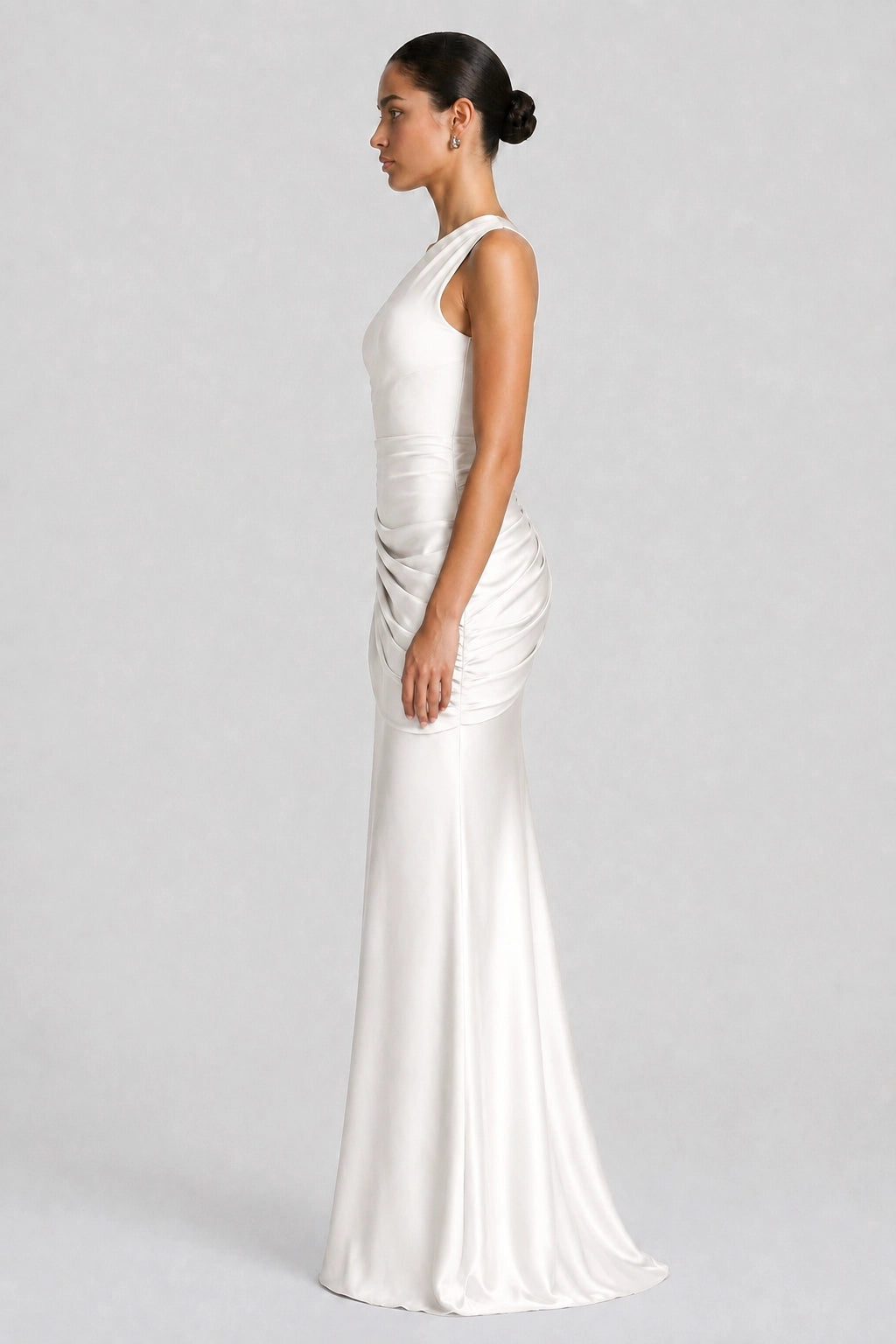 White one-shoulder satin gown, side profile with ruched waist detail