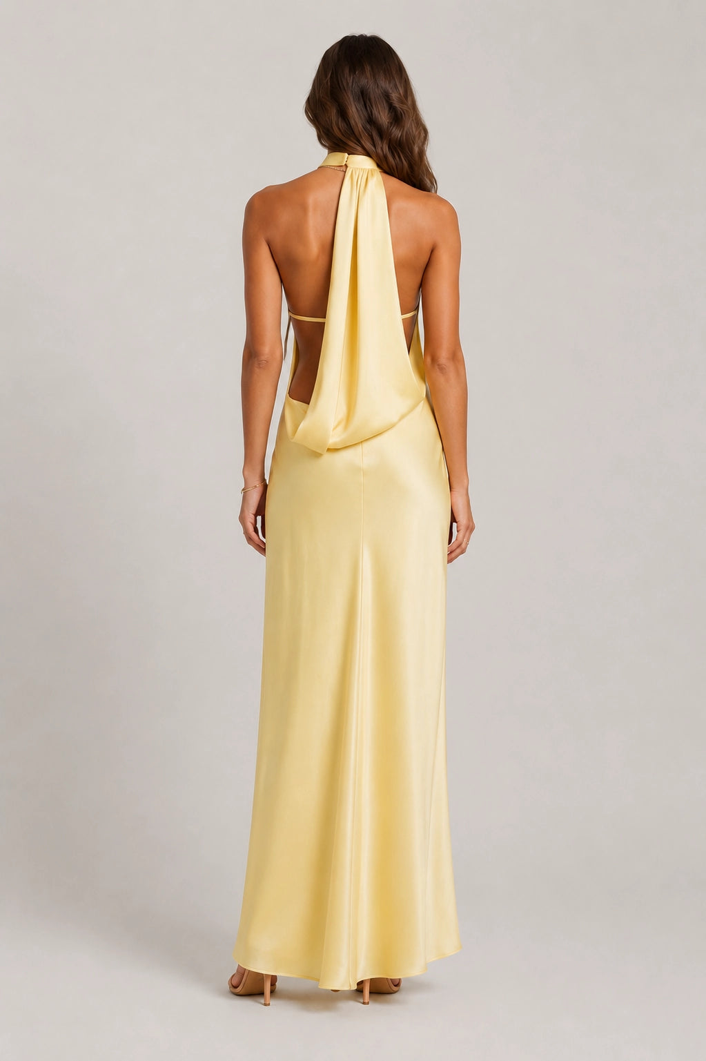 Yellow satin maxi dress with open back, halter straps, and back tie